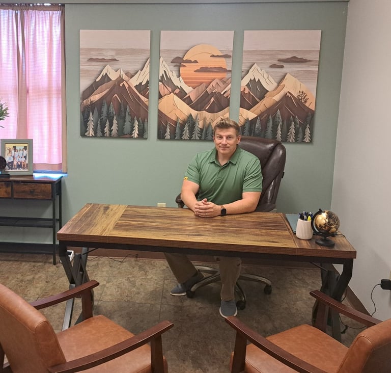 Daniel Ferguson sitting in his office at a desk.