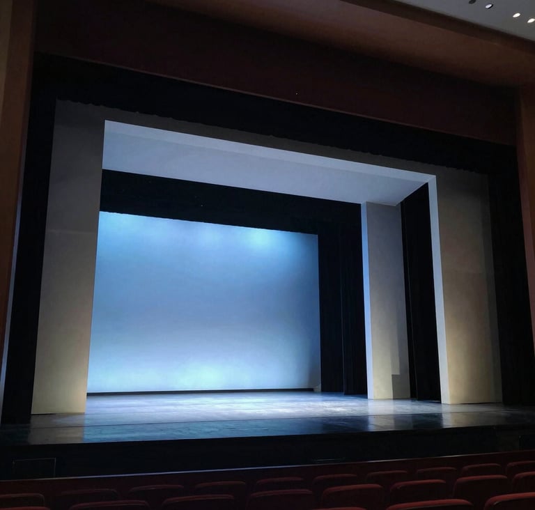 A wide photography shot of a professional theater stage in the US, featuring a modern set design with clean lines and muted blue lighting, sophisticated and contemporary atmosphere.