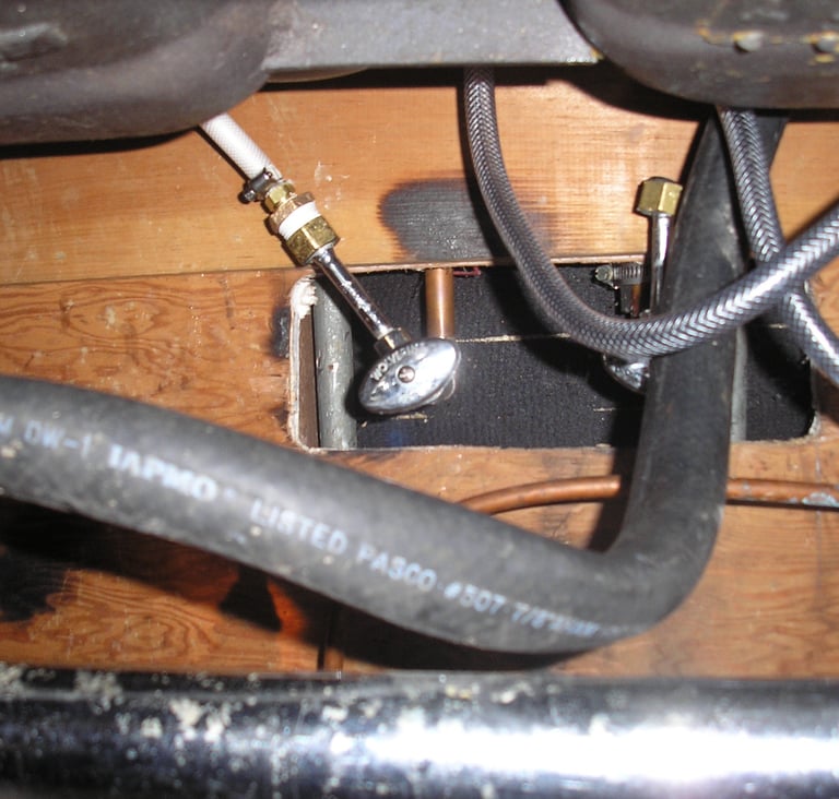 Underneath sink checking for leaks. Building maintenance.