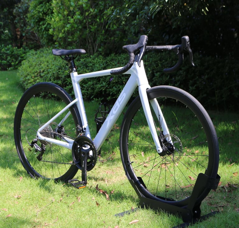 XDS AD350 road bike with disc brakes parked on a green grass lawn.