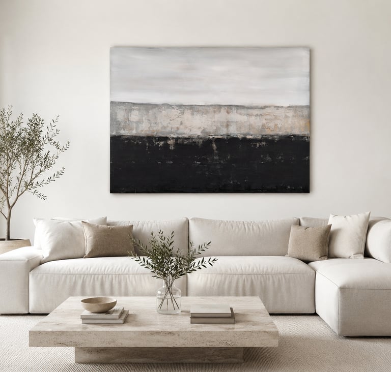 Modern living room with a white sectional sofa, stone coffee table, and large abstract landscape wall art.