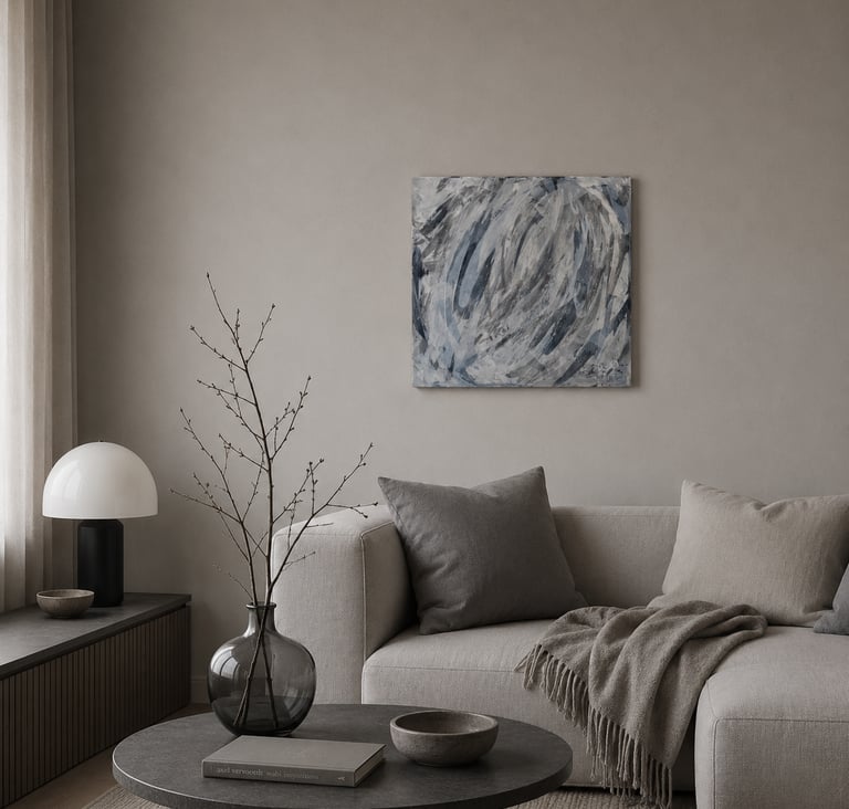 Modern minimalist living room featuring a neutral sofa, abstract wall art, and a designer table lamp.