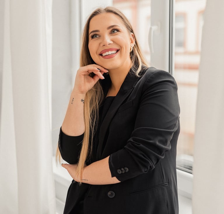 a woman in a black jacket and a white shirt