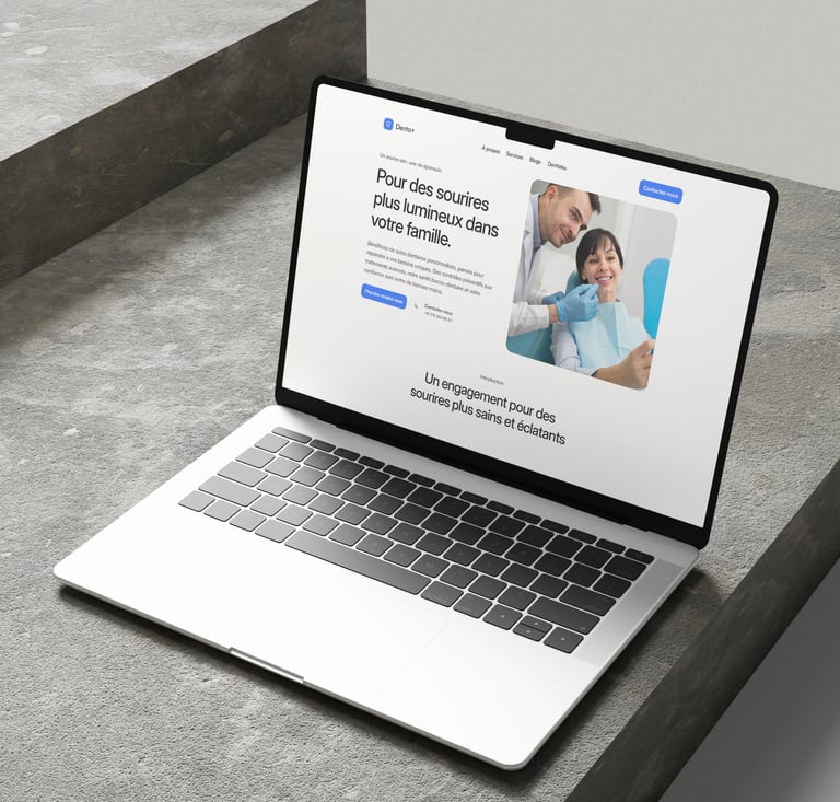 A laptop on a table displaying the Dento+ website