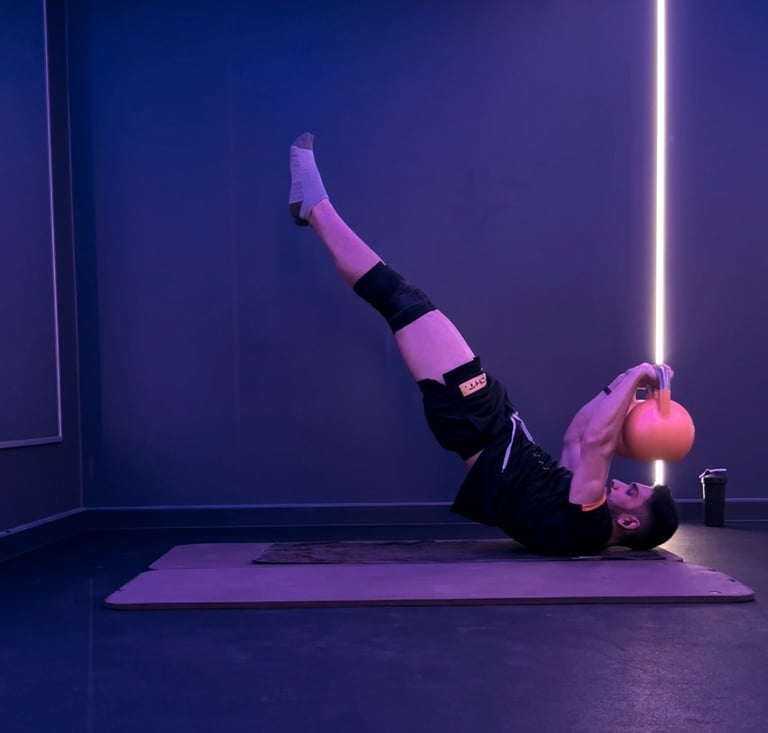 A man doing a dragon flag with bells. Calisthenics.