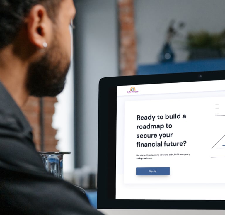 a man sitting at a computer screen with a laptop and looking at the Dollary Harmony App