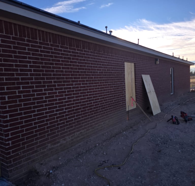 before the brick demolition begins with boarded windows by Contractor
