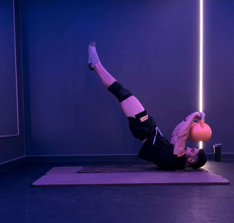 A man doing a dragon flag with bells. Calisthenics.