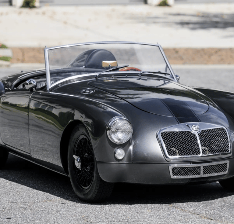 3/4 profile view of a silver 1958 MG MGA Roadster.
