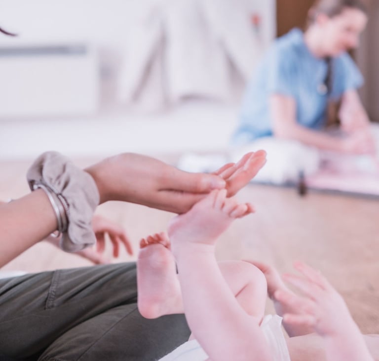 Parent and baby taking part in a gentle baby yoga class at Radwinter Pavilion near Saffron Walden