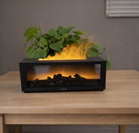 Fireplace-Style LED Essential Oil Diffuser on a wood table in front of a plant 
