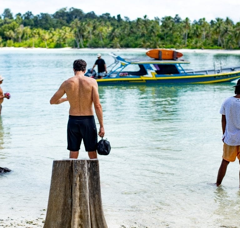 a man standing in the water with a helmet on