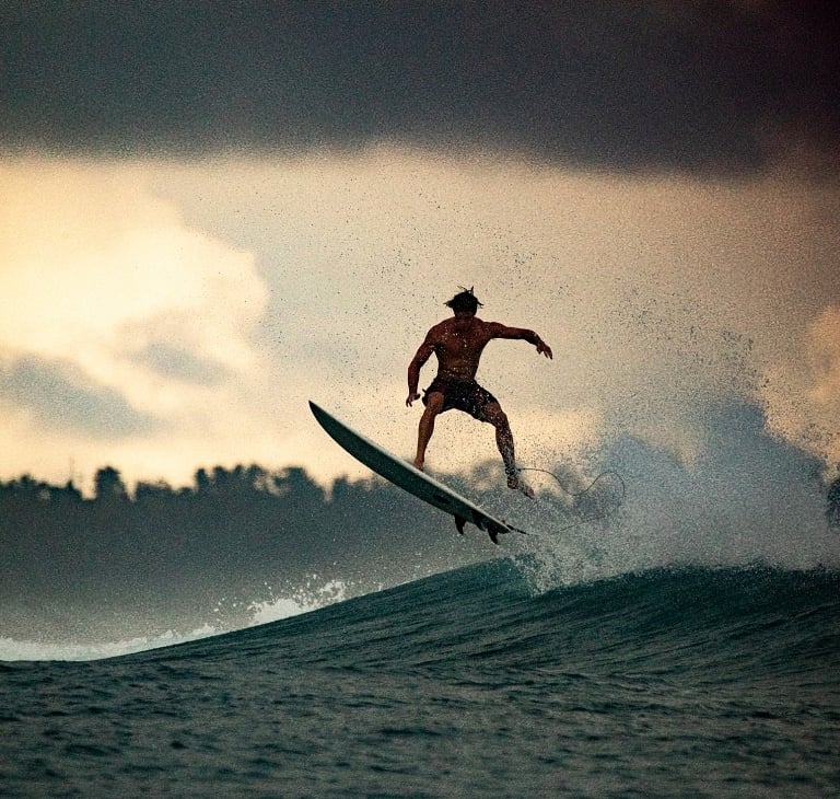 a man is surfing on a wave in the ocean