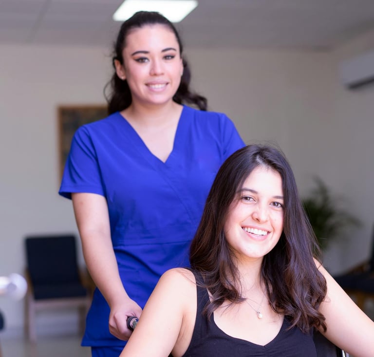 a woman in a wheelchair with a nurse