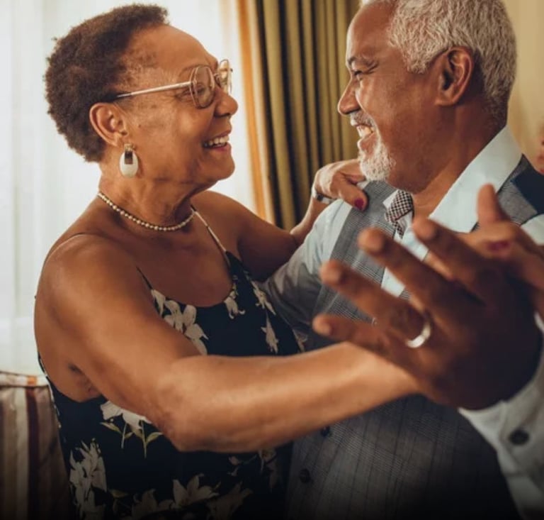 casal de idosos dançando na sala