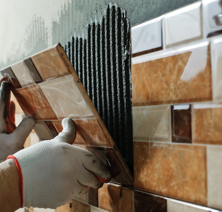 installing tile on a wall with grout