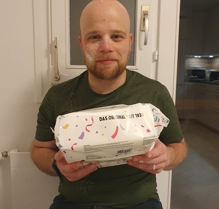 Colin from Hidden Switzerland Travel with a box of Fasnachtschüechli, traditional carnival food