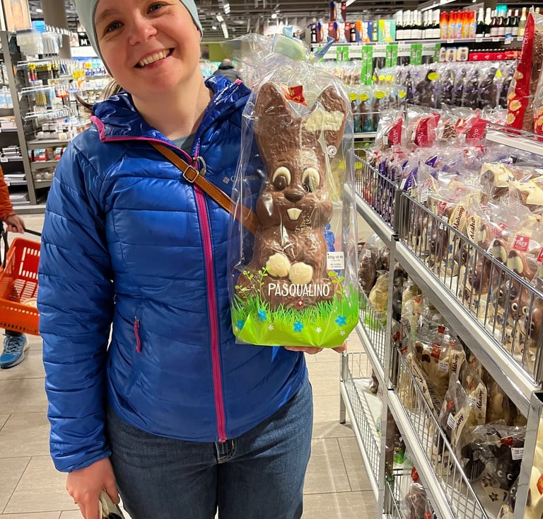 Picture of Corinne from Hidden Switzerland Travel holding a chocolate easter bunny