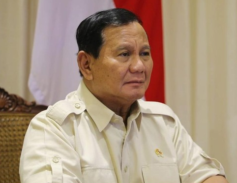 a man in a military uniform sitting at a table