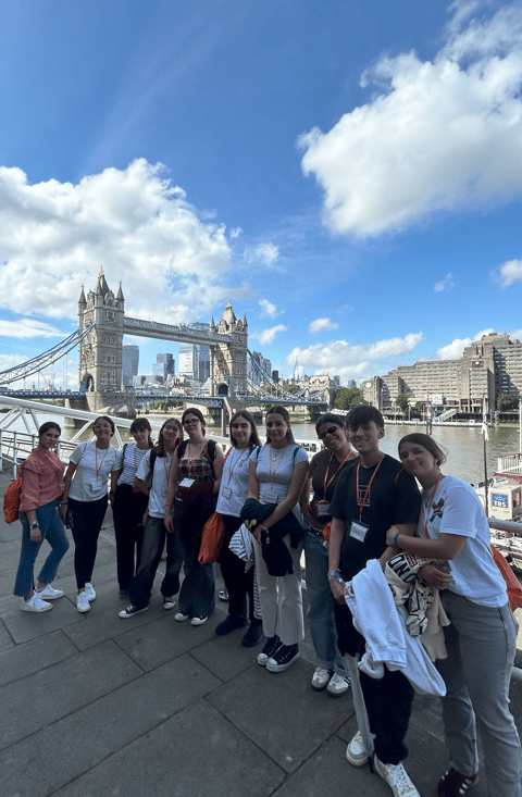 Un grupo de estudiantes de Priegoenglish por Londres, con el Tower Bridge al fondo.