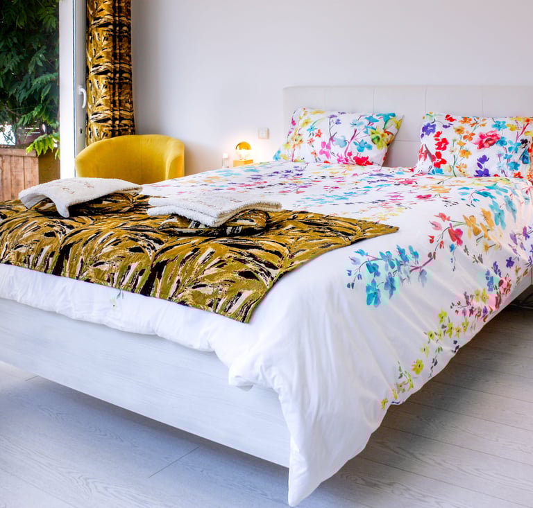 Bed with full bedding, floating bed with two with swimming pool in flower colours at Domaine Des Lucques