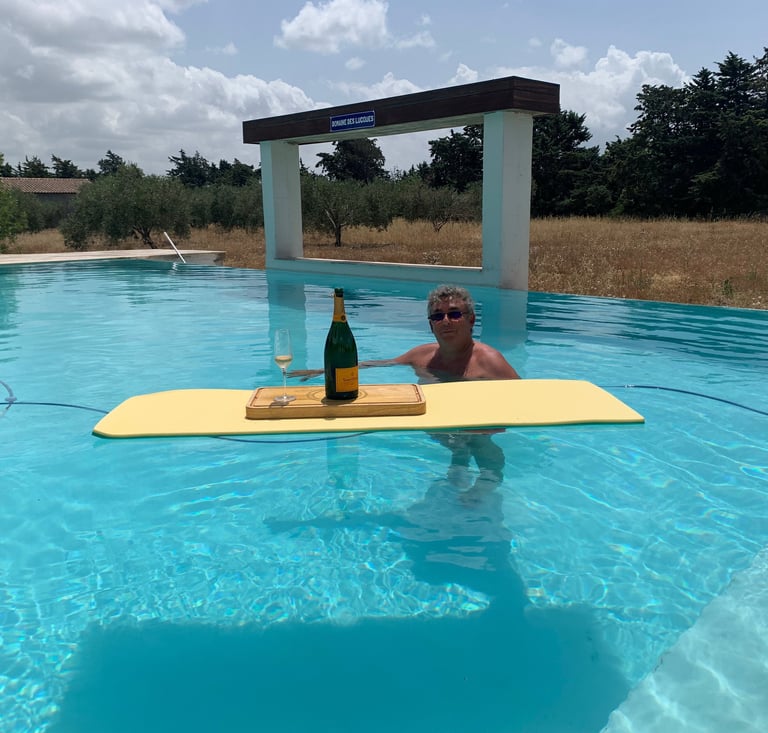 Guest enjoying the infinity swimming pool at Domaine Des Lucques