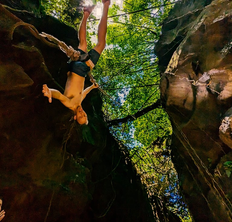 a man is doing a trick on a canyon rock climbing