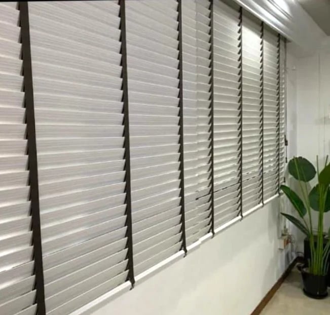 a room with a large window with Pvc Venetian Blind