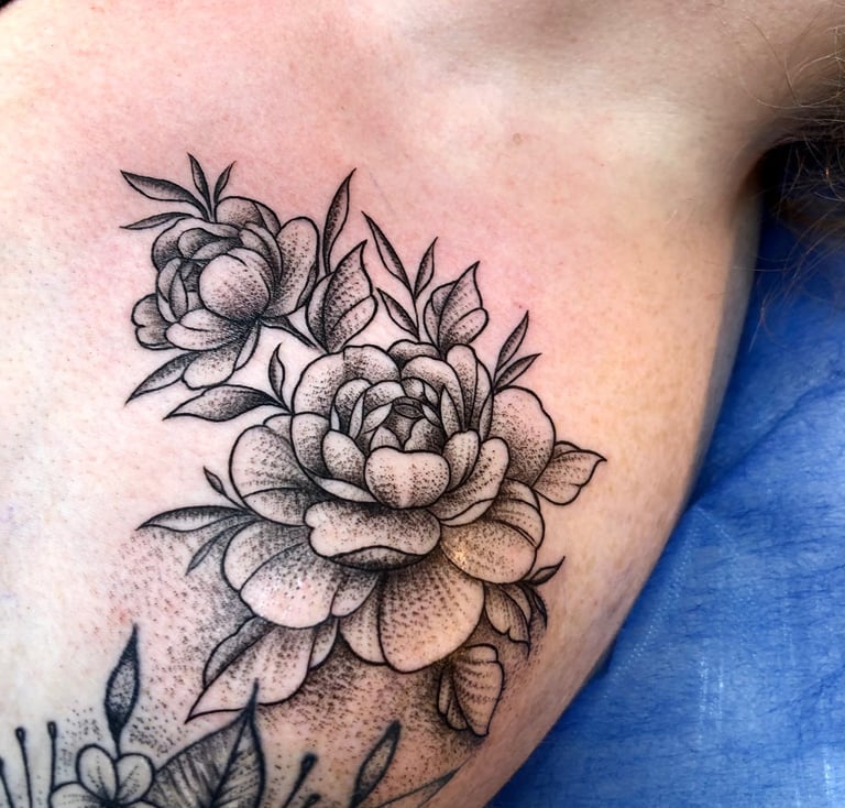Lily tattoo in fine line on chest — Hurghada Tattoo Studio