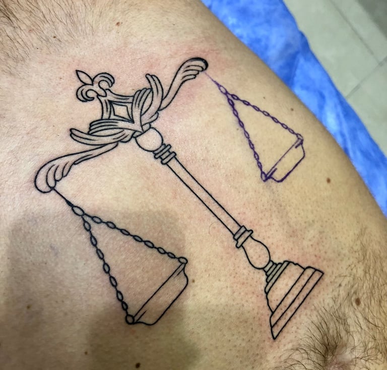 Blackwork balance tattoo on chest — Hurghada Tattoo Studio