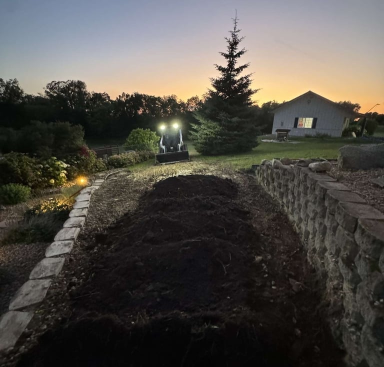 skid-steer-spreading-dirt-for-landscaping-project.jpg