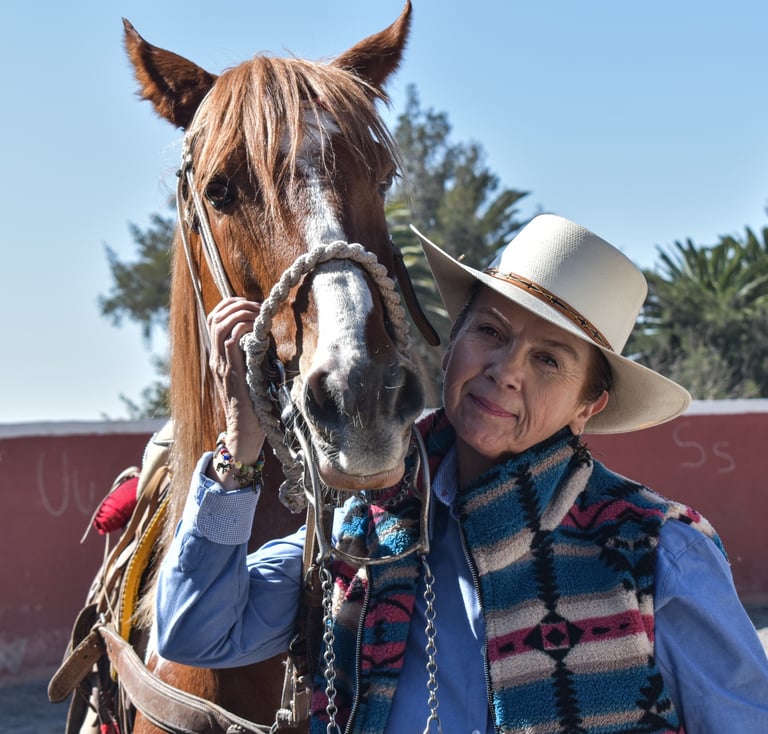a woman in a cowboy hat and a horse