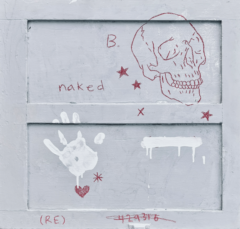 Rough painting of a human skull a handprint stars and hearts on wood