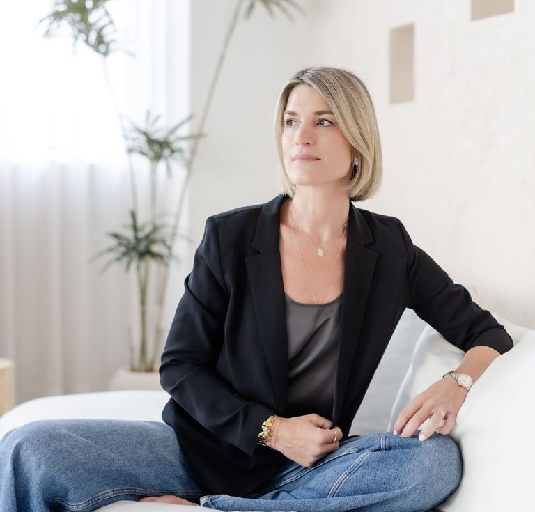 Psychotherapist Yvonne smiling, soft lighting, reflective and calm expression.