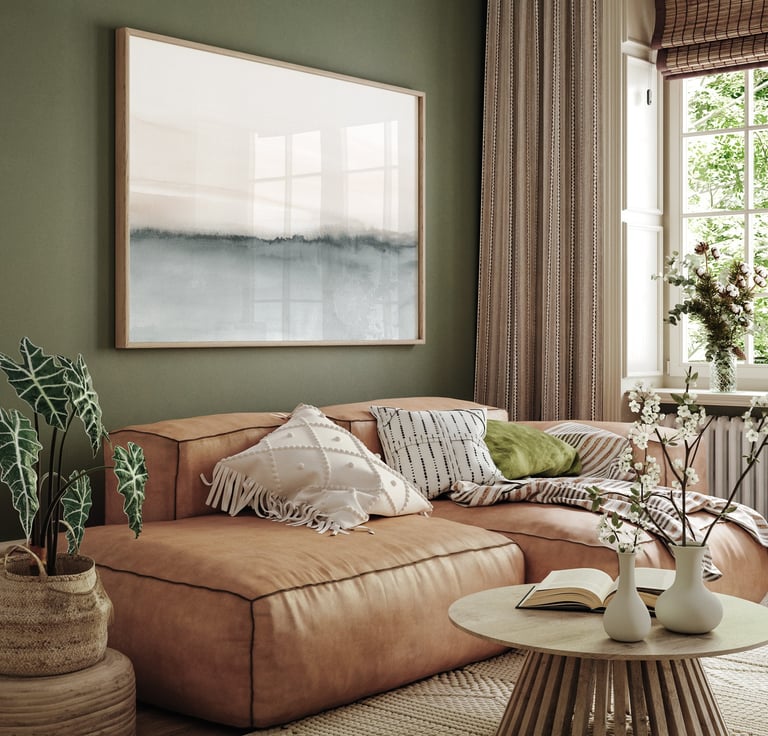 Minimalist abstract landscape with soft grey-beige gradients framed above a leather sofa