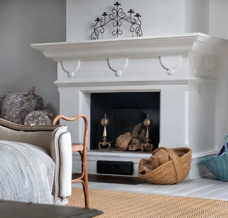 Fireplace with baskets and decor at Finca Santa Katerina