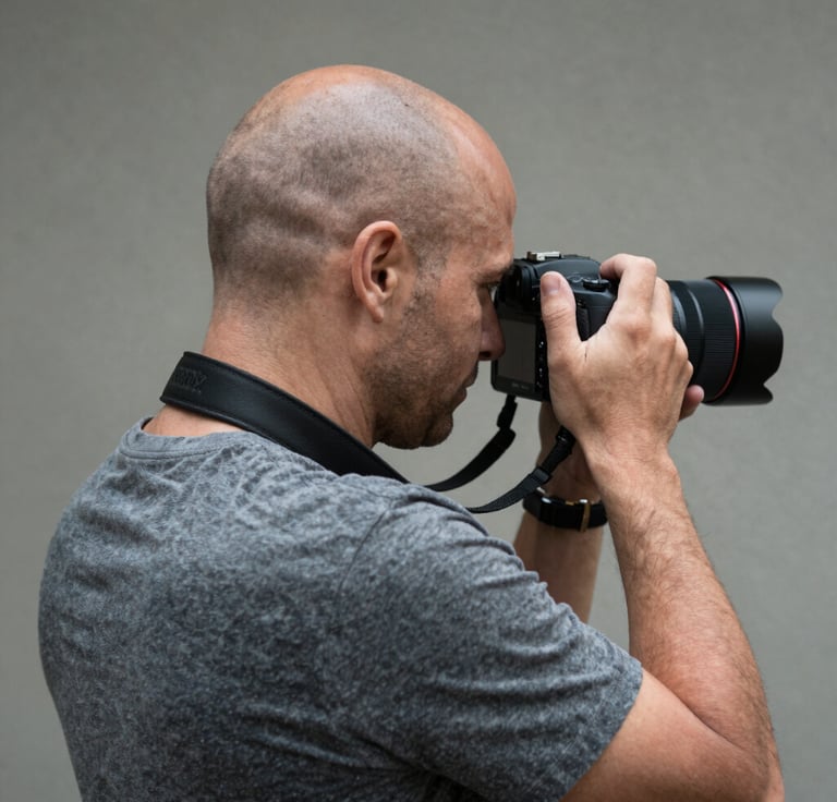 A professional video production suite with a dual-monitor setup showing timeline editing software, studio lighting equipment in the periphery, and a sleek modern desk, featuring a color palette of navy, slate, and light grey to evoke organized expertise.