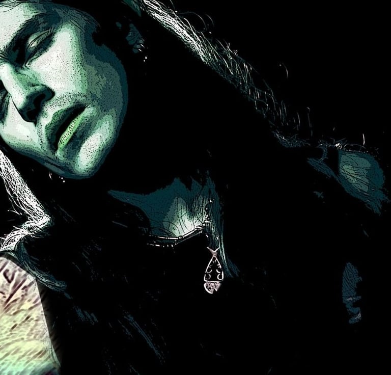 A handsome, long-haired, tattooed man in green and black hues