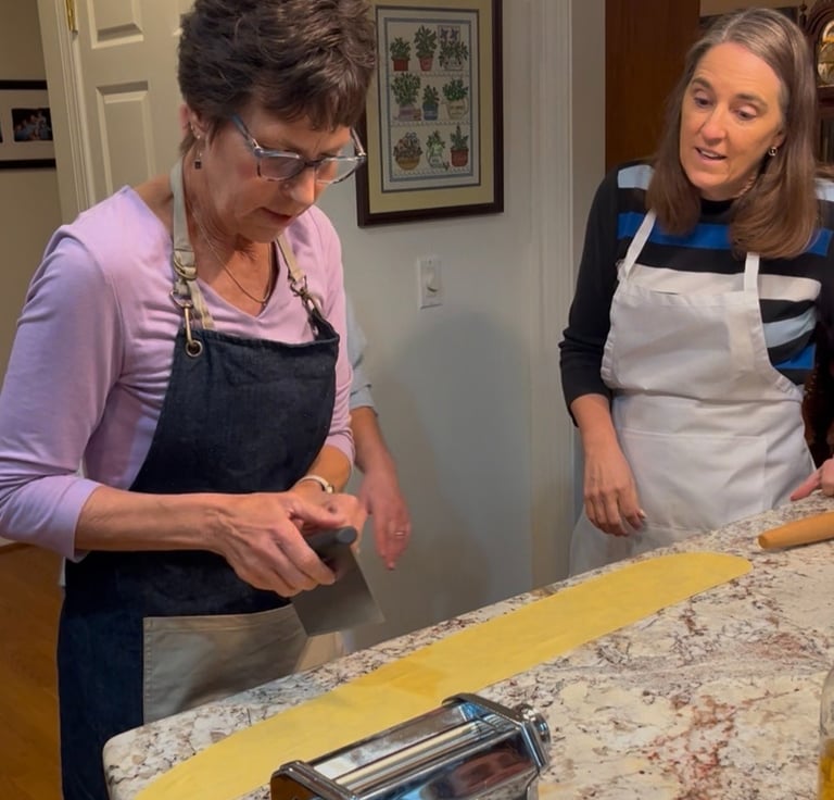 Michele demonstrating how to cut a fresh handmade pasta noodle