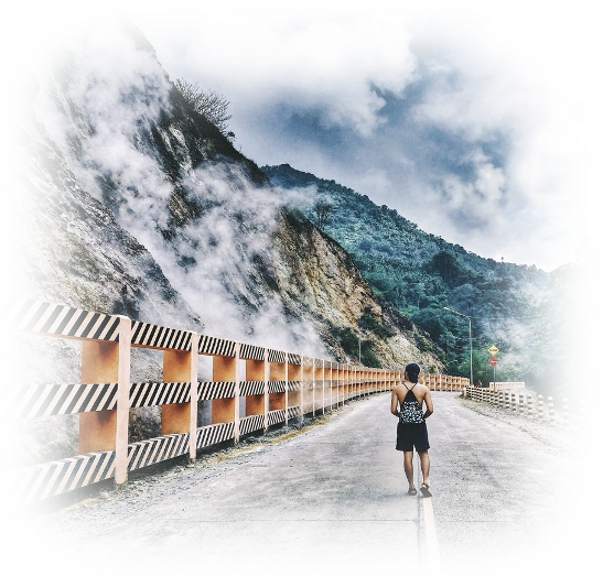 a person walking down a road with a backpack