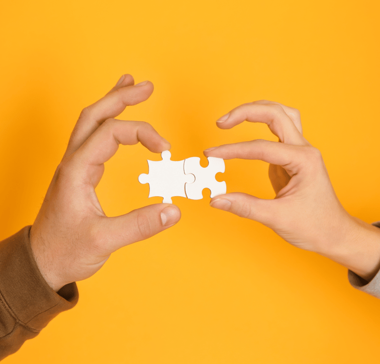 two hands holding a puzzle piece of puzzle pieces