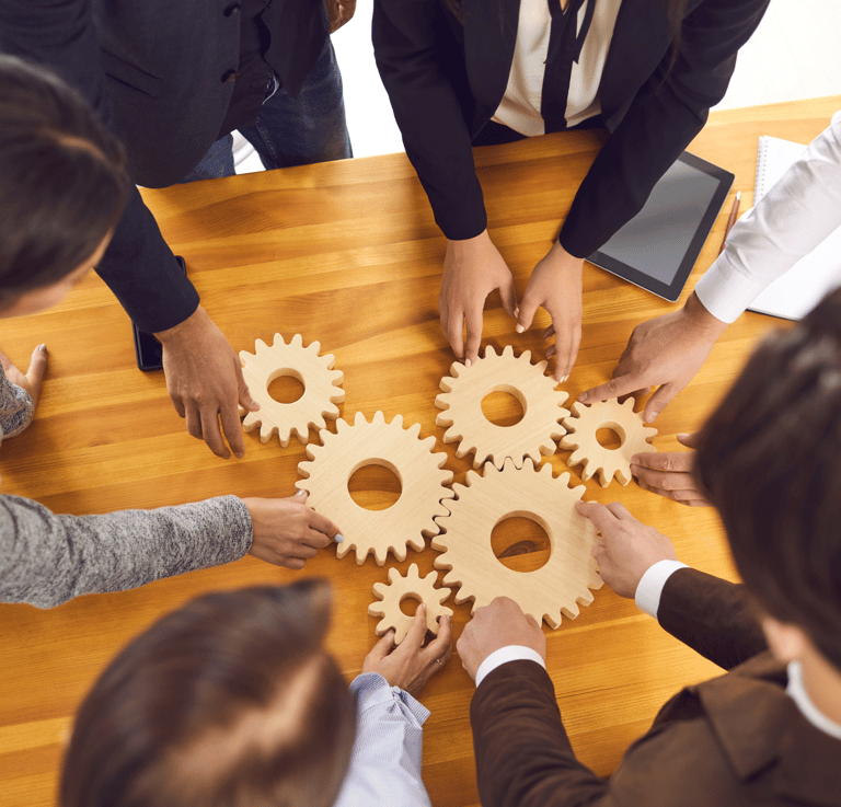 a group of people standing around a table with gear
