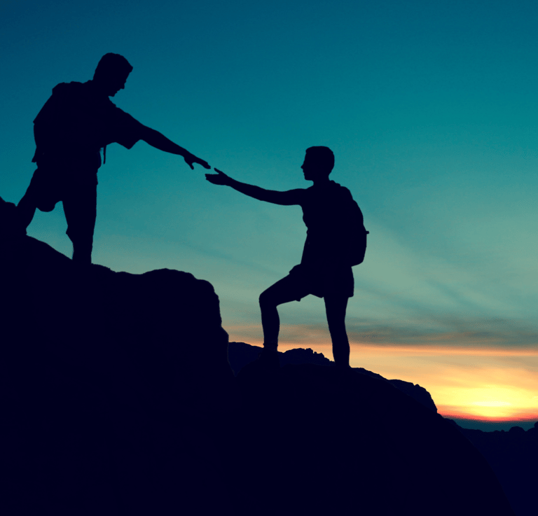 a man and woman holding hands on a mountain