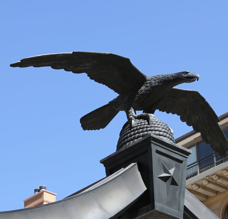 Eagle Gate, a statue of a bald eagle with wings spread atop a beehive