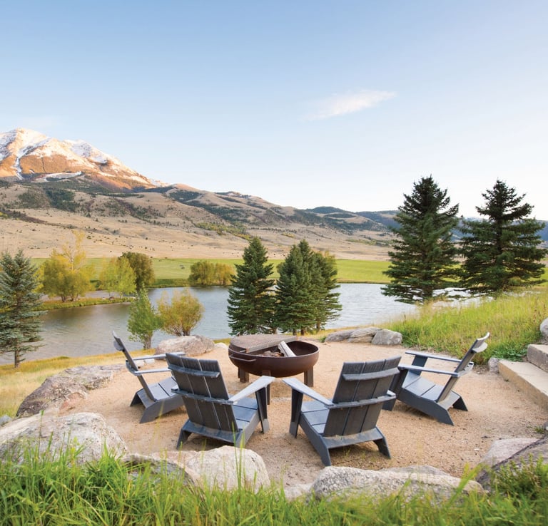 fire pit and chairs overlooking a lake