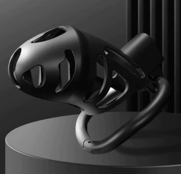 a black and white chastity cage on a pedestal 