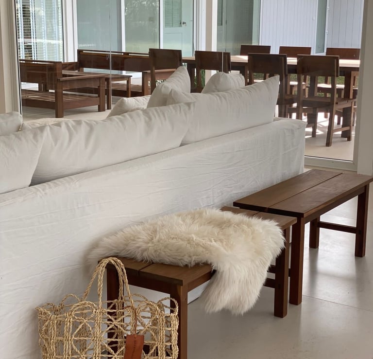 a couch with a basket bag on top of it