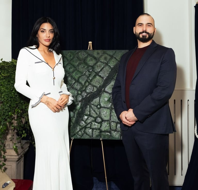 a man and woman standing in front of a painting