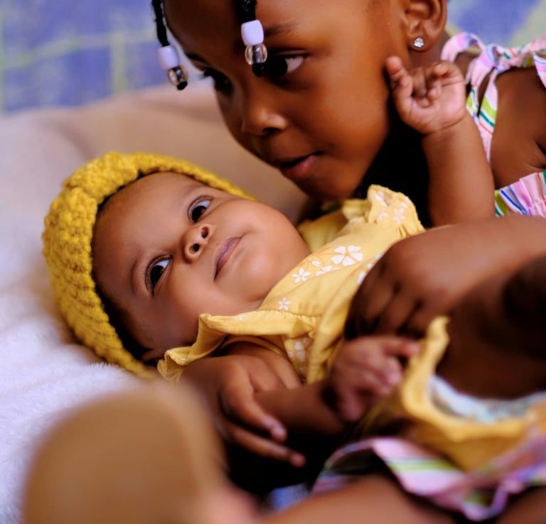 a baby girl in a yellow dress and a yellow hat
