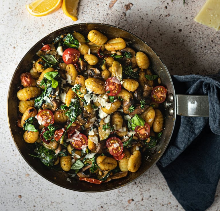 pan of gnocchi, cherry tomatoes, parmesan and basil